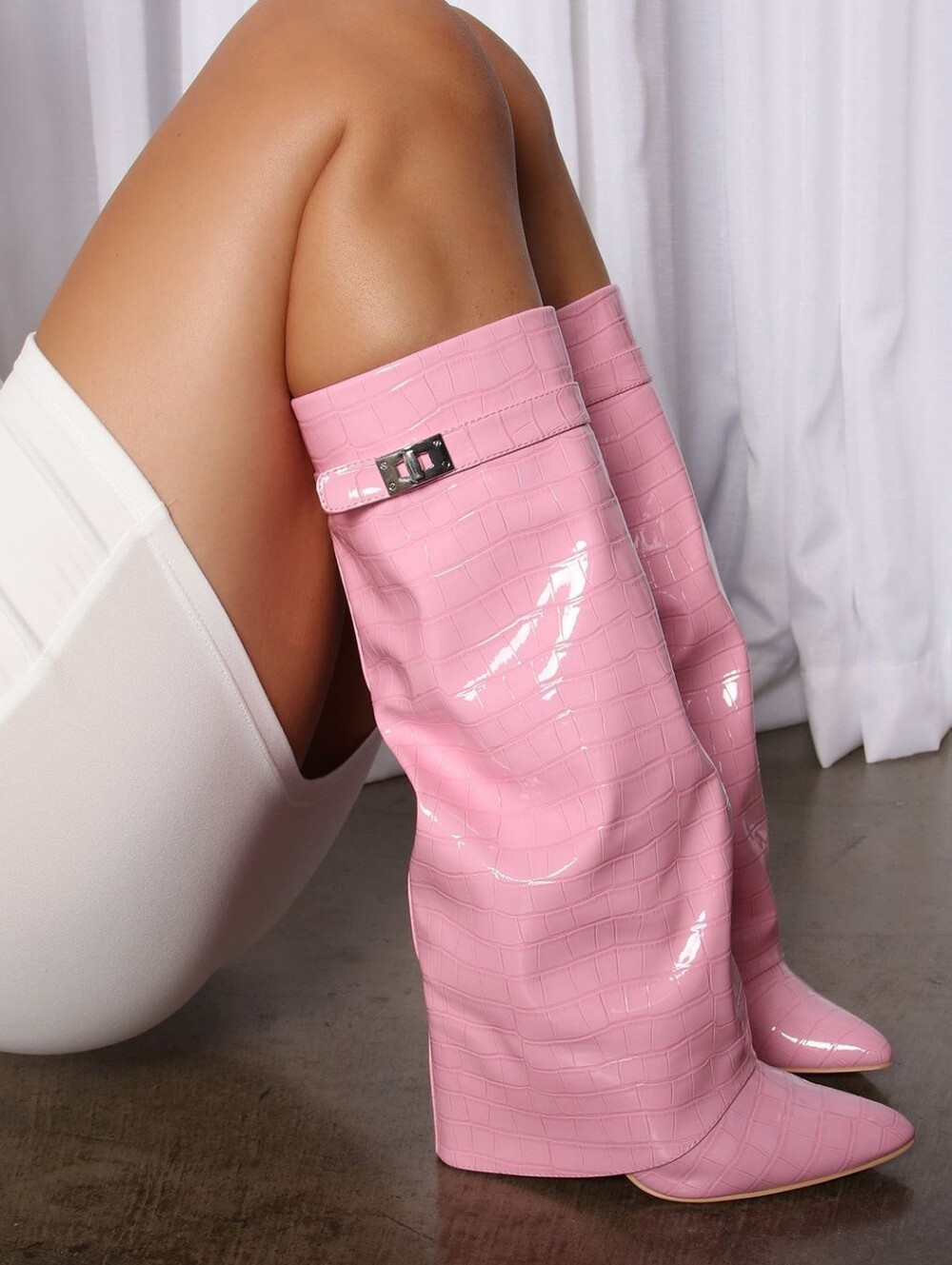 Stylish pink women's high-heeled boots with a bright and modern design